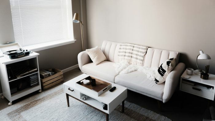 white couch in front of white wooden table