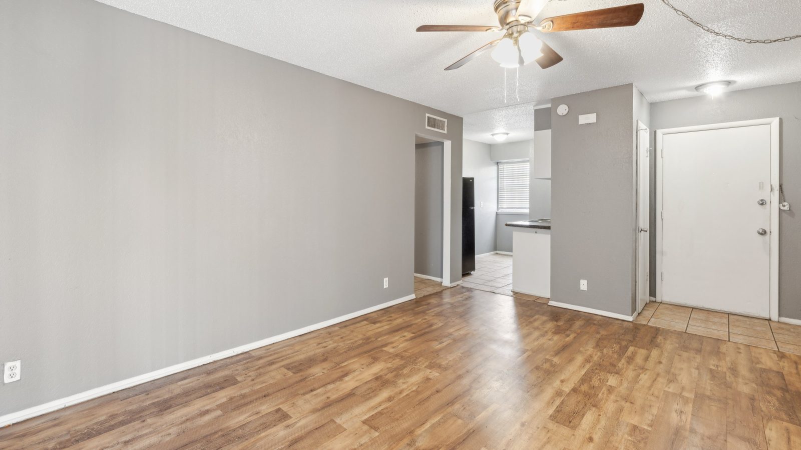 empty room with hardwood floors and ceiling fan at The Crestwood Terrace