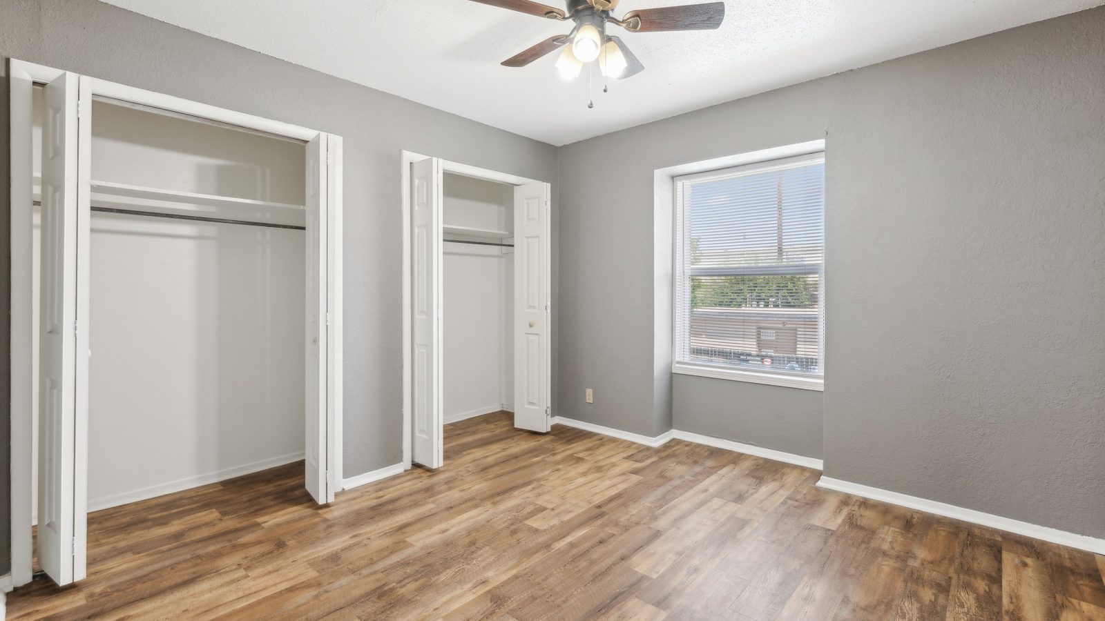 empty room with hardwood floors and ceiling fan at The Crestwood Terrace