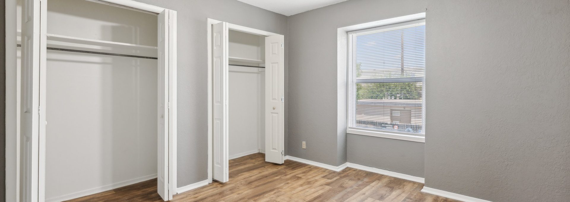 empty room with hardwood floors and ceiling fan at The Crestwood Terrace