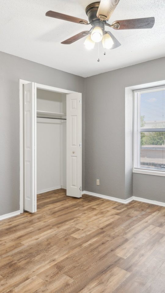 empty room with hardwood floors and ceiling fan at The Crestwood Terrace